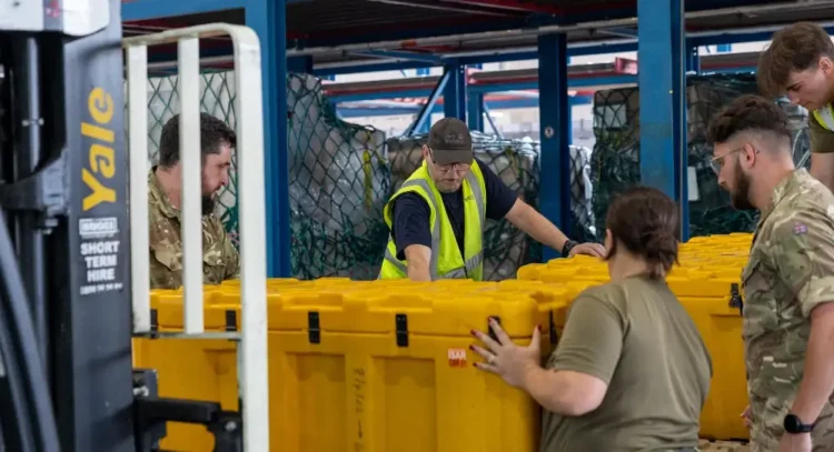 RAF Movers from No.1 Air Mobility Wing build up pallets of humanitarian aid and specialist equipment. Photo by the MOD Crown Copyright.