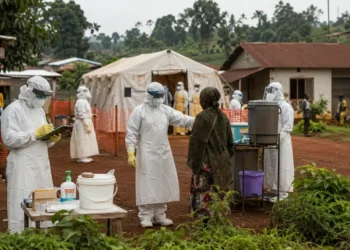 Health workers in protective equipment support Ebola screening and treatment operations in eastern DRC.
