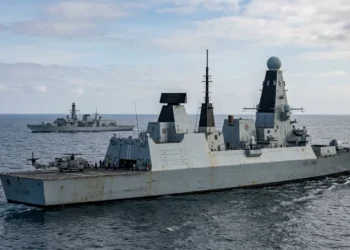 AI-generated photograph-style image of Royal Navy warships conducting maritime operations with a naval helicopter at sea.