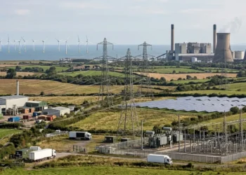 AI-generated illustration of UK energy infrastructure with offshore wind, solar power, electricity pylons and conventional generation.