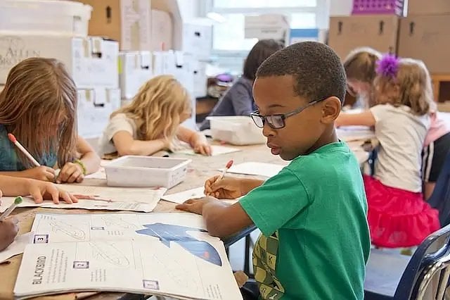 Young children hard at work in the classroom. Photo by the CDC. Unsplash.