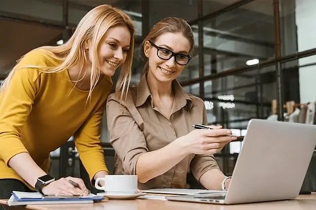 Women working in an office. Photo by Pixabay.
